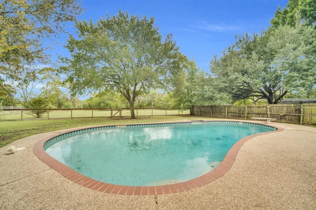 a view of a swimming pool with a yard