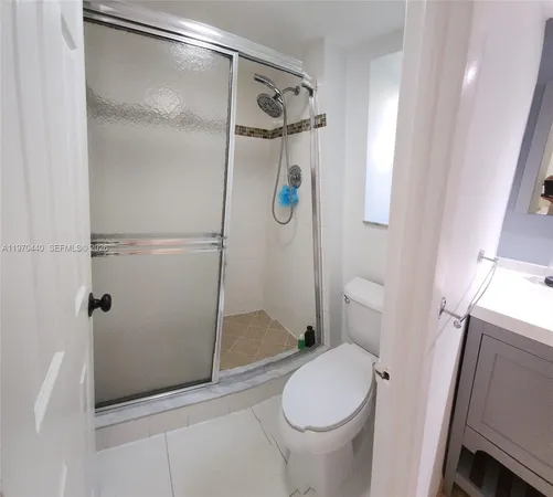 a bathroom with a shower and toilet