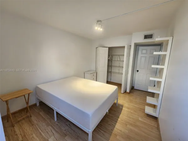 a bedroom with a bed and closet