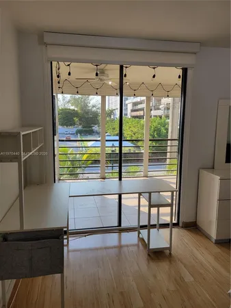 a view of a room with furniture and a window