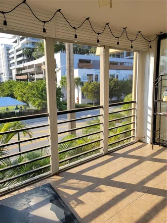a view of a porch with a table and chairs