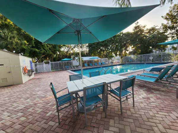 an outdoor space with furniture and umbrella