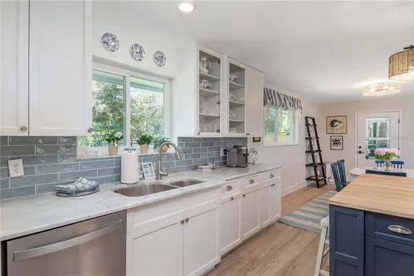 a kitchen with sink and cabinets