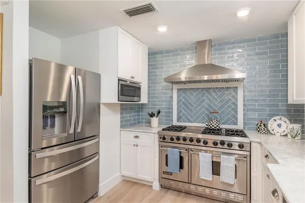 a kitchen with a stove and a refrigerator