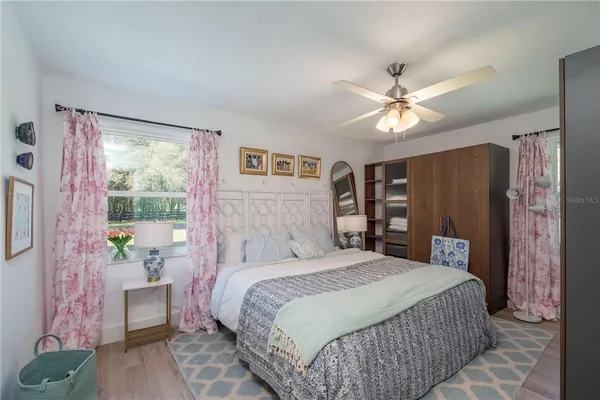 a bedroom with a large bed and a window