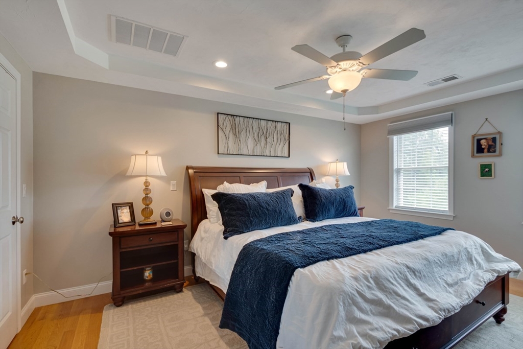 4 Rhodes Drive, Unit 4 Berlin, MA 01503 - Photo 16 of 30 a bedroom with a bed and a chandelier