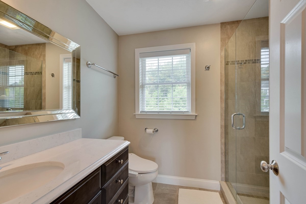 4 Rhodes Drive, Unit 4 Berlin, MA 01503 - Photo 18 of 30 a bathroom with a sink a toilet and shower