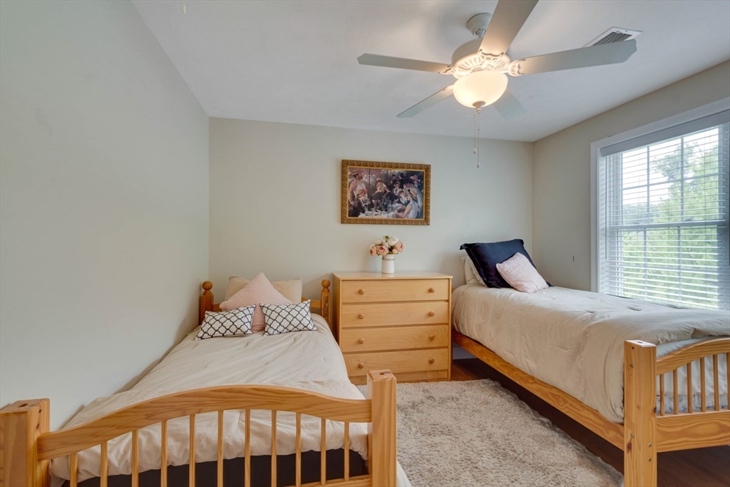 4 Rhodes Drive, Unit 4 Berlin, MA 01503 - Photo 19 of 30 a bedroom with a bed and a chandelier