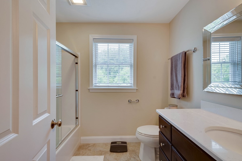 4 Rhodes Drive, Unit 4 Berlin, MA 01503 - Photo 21 of 30 a bathroom with a sink a toilet a shower and a window