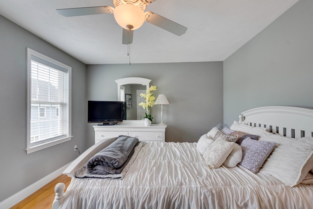 4 Rhodes Drive, Unit 4 Berlin, MA 01503 - Photo 23 of 30 a bedroom with a bed and a flat screen tv