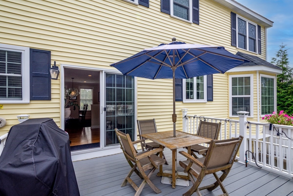 4 Rhodes Drive, Unit 4 Berlin, MA 01503 - Photo 24 of 30 a patio with table and chairs and potted plants
