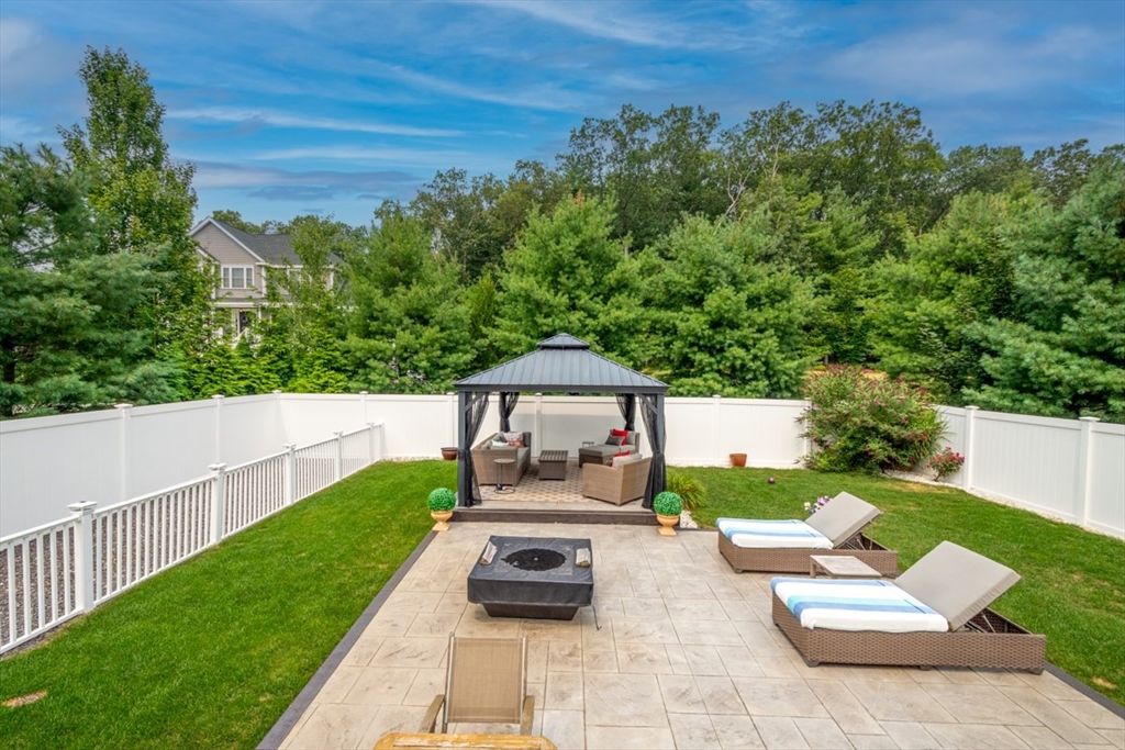 4 Rhodes Drive, Unit 4 Berlin, MA 01503 - Photo 26 of 30 a view of a patio with chairs and a yard