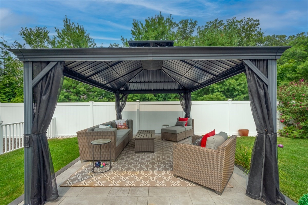 4 Rhodes Drive, Unit 4 Berlin, MA 01503 - Photo 29 of 30 a backyard of a house with seating space