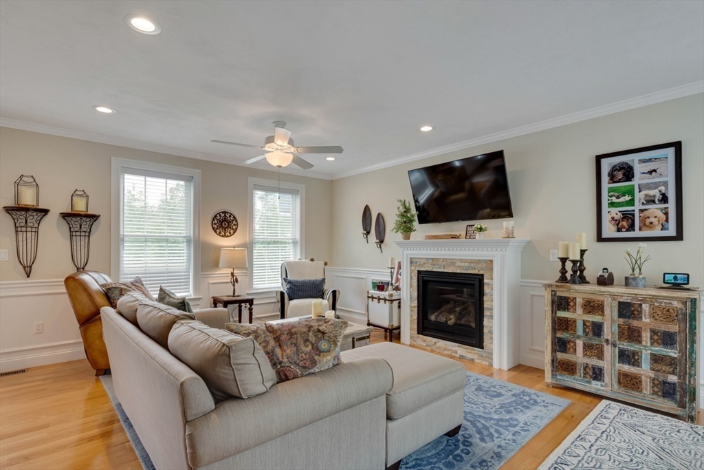 4 Rhodes Drive, Unit 4 Berlin, MA 01503 - Photo 4 of 30 a living room with furniture a flat screen tv and a fireplace