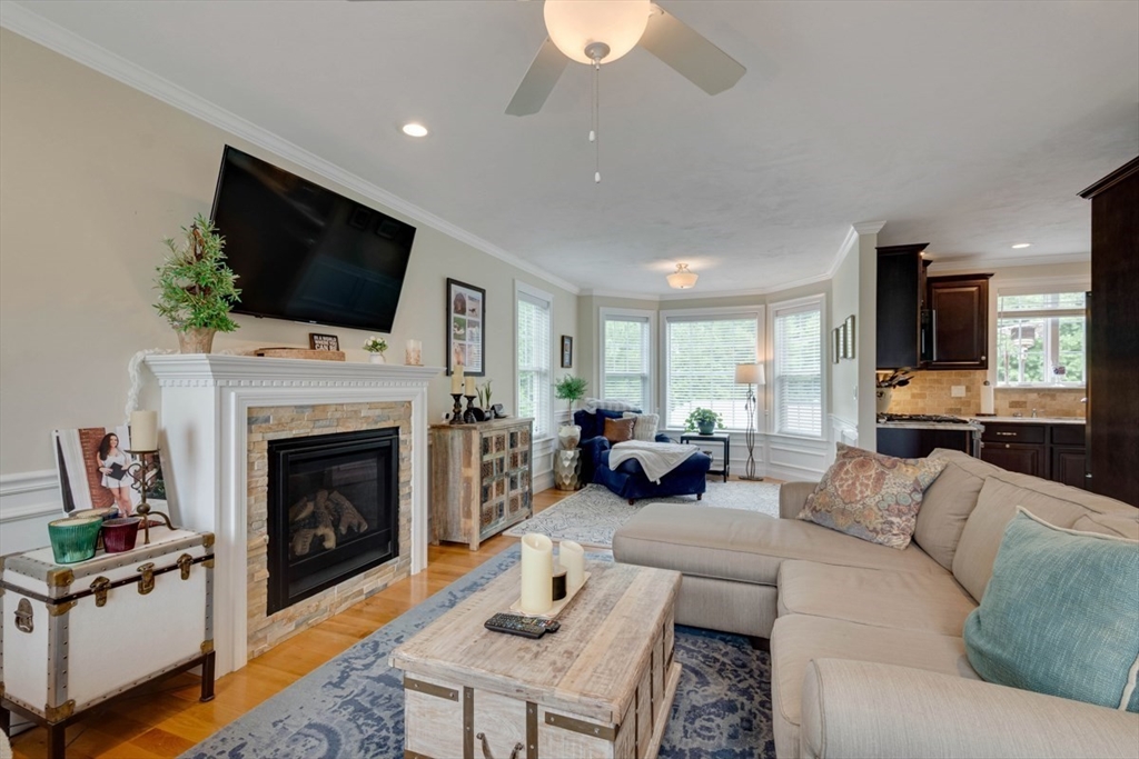 4 Rhodes Drive, Unit 4 Berlin, MA 01503 - Photo 6 of 30 a living room with furniture a fireplace and a flat screen tv