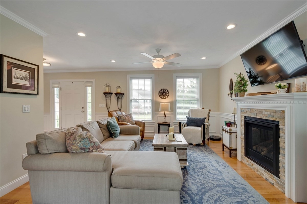 4 Rhodes Drive, Unit 4 Berlin, MA 01503 - Photo 7 of 30 a living room with furniture a fireplace and a flat screen tv