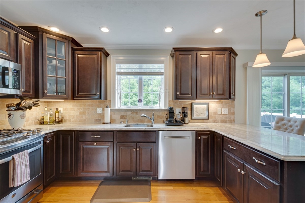 4 Rhodes Drive, Unit 4 Berlin, MA 01503 - Photo 10 of 30 a kitchen with a sink stove and cabinets