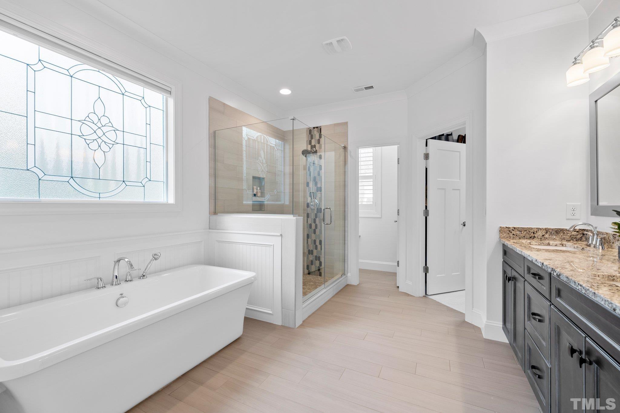 9508 Oakhurst Court Raleigh, NC 27614 - Photo 28 of 67 Elegant free standing tub, separate shower with custom tile work, granite counters, & a double vanity.