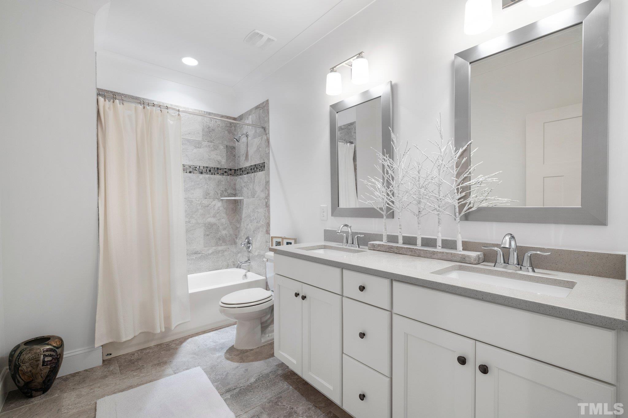 9508 Oakhurst Court Raleigh, NC 27614 - Photo 40 of 67 Granite counters, double vanities, tub/shower with custom tile surround, & ceramic floors.
