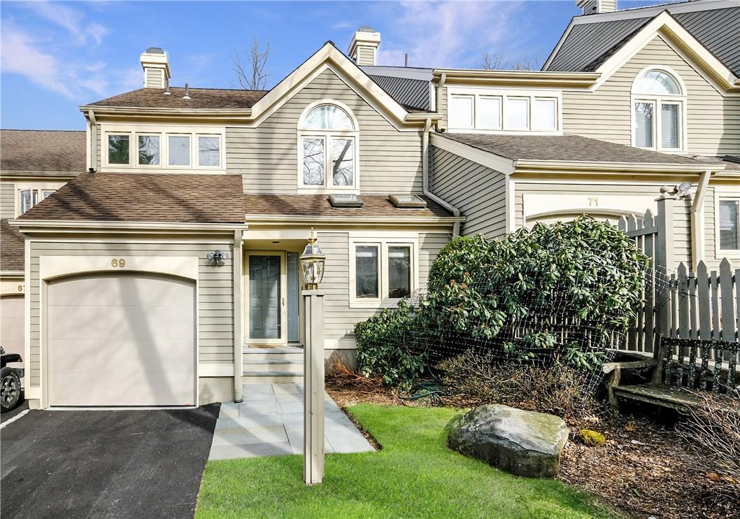69 Boulder Ridge Road Scarsdale, NY 10583 - Photo 1 of 1 a front view of a house with a yard and garage