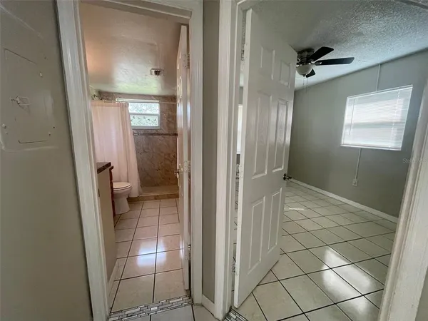a bathroom with a glass door shower and a sink