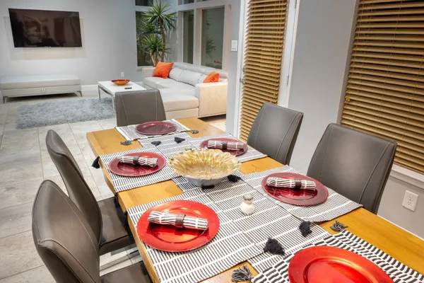 a living room with dining room and wooden floor