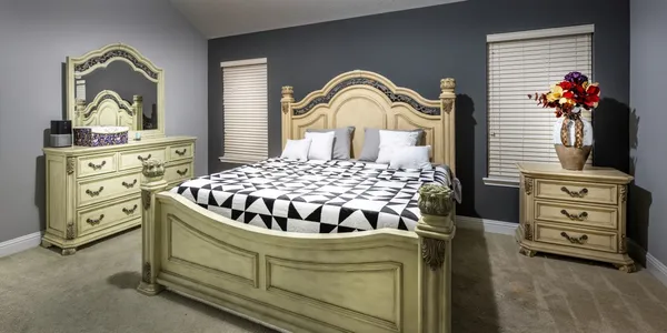 a bedroom with a bed and a dresser