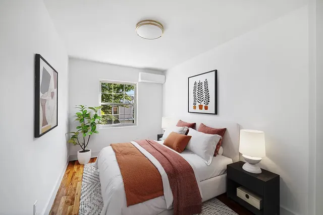 a bedroom with a bed and a window