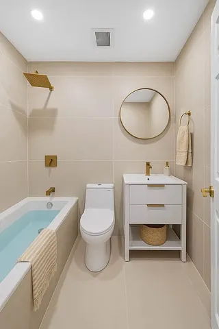 a bathroom with a toilet a sink a mirror and bathtub