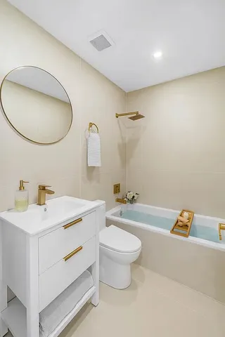 a bathroom with a sink a toilet and a mirror