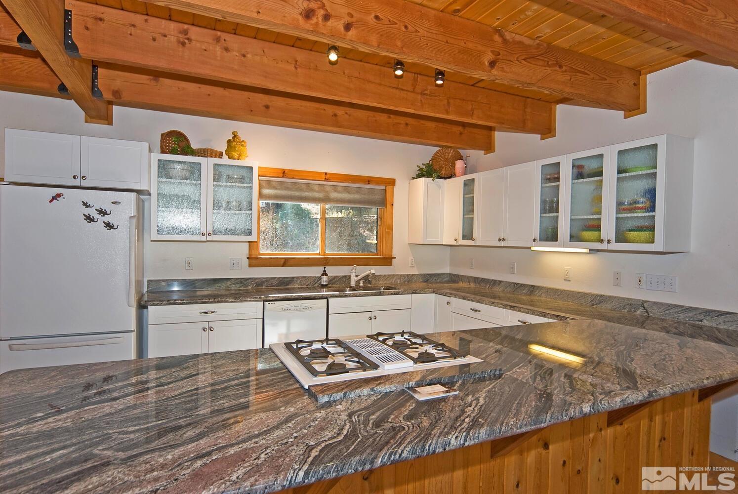 125 Pleasant Valley Road Markleeville, CA 96120 - Photo 12 of 36 a large kitchen with granite countertop a sink and a stove