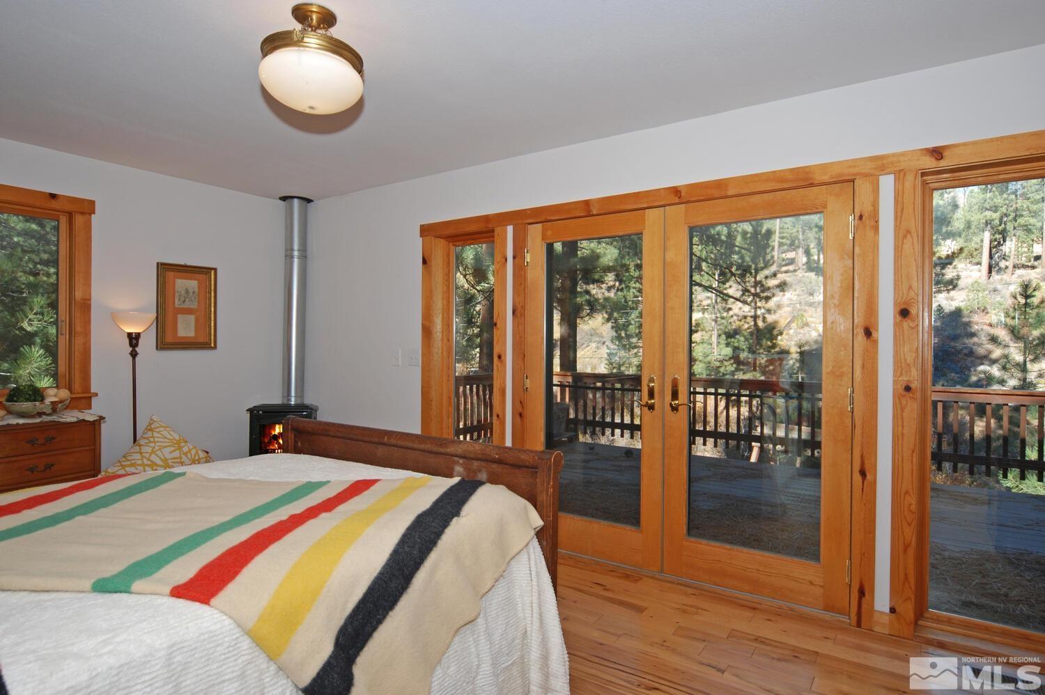 125 Pleasant Valley Road Markleeville, CA 96120 - Photo 23 of 36 a bedroom with a bed and wooden floor
