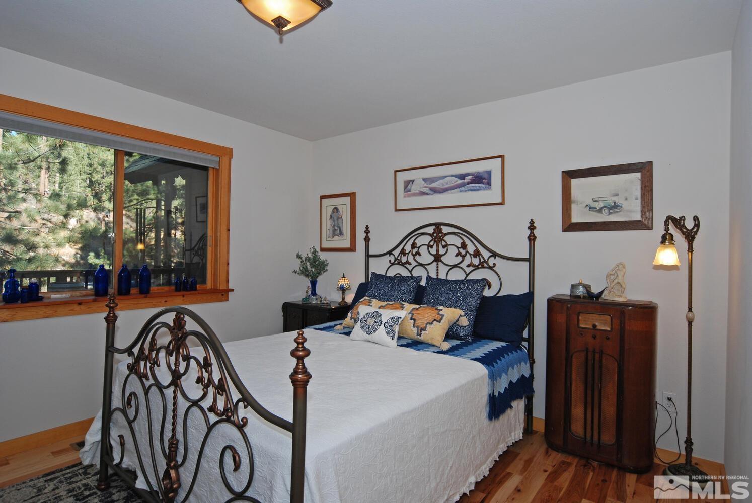125 Pleasant Valley Road Markleeville, CA 96120 - Photo 27 of 36 a bedroom with a bed and a chandelier