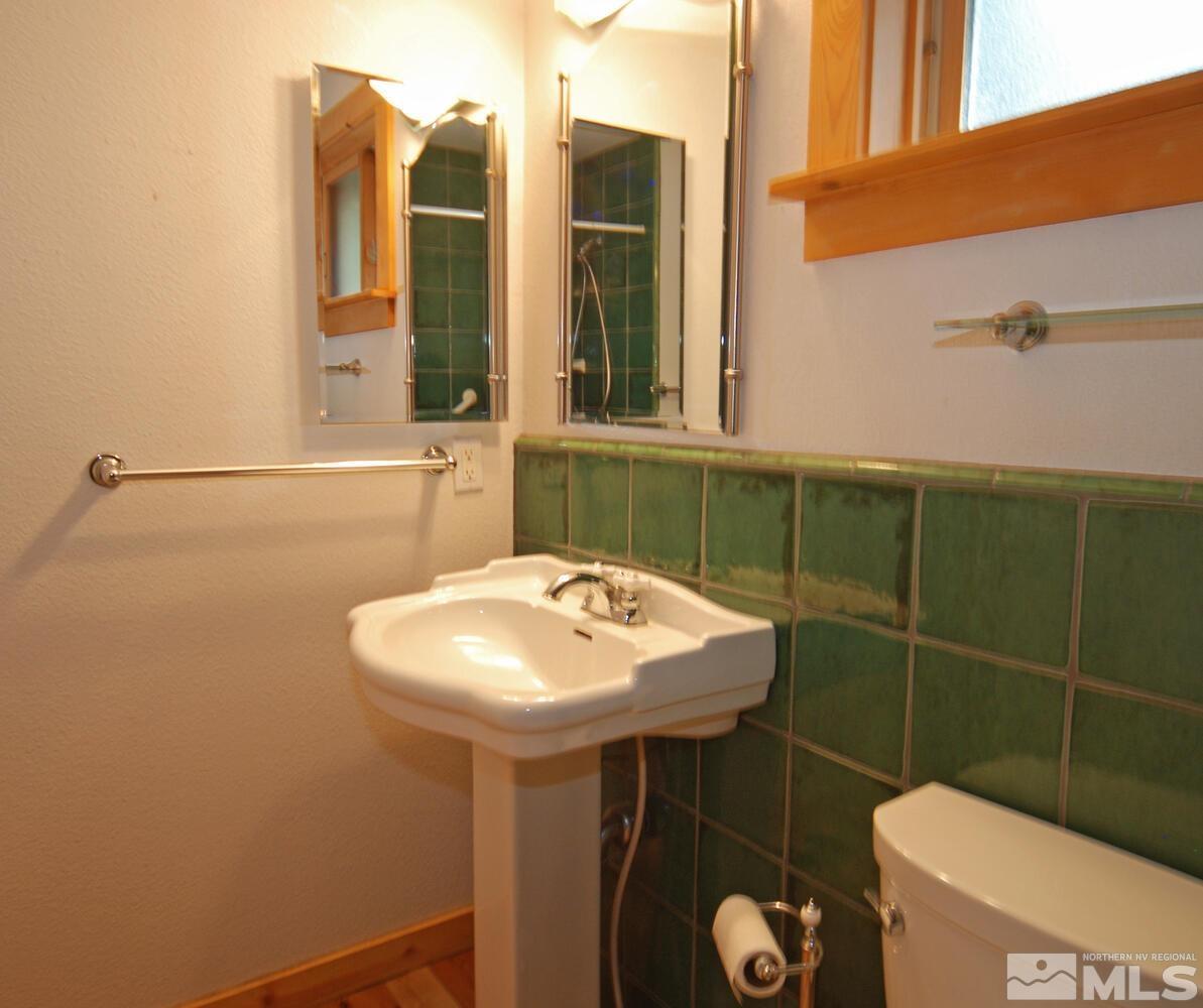 125 Pleasant Valley Road Markleeville, CA 96120 - Photo 29 of 36 a bathroom with a sink toilet and a mirror