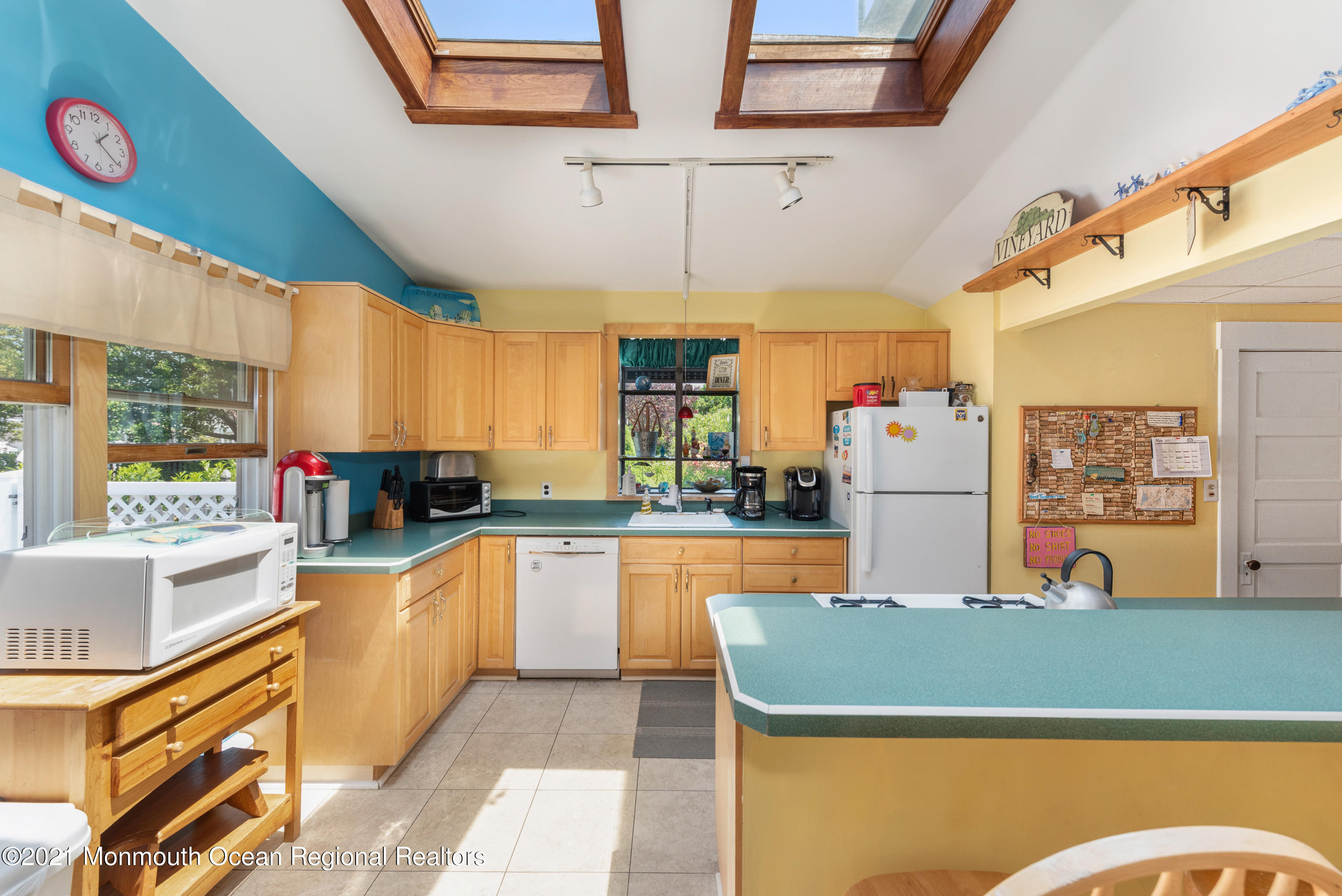 1709 Brighton Lane, Unit WINTER 2324 Spring Lake, NJ 07762 - Photo 11 of 27 a kitchen with stainless steel appliances granite countertop a table chairs in it and a window