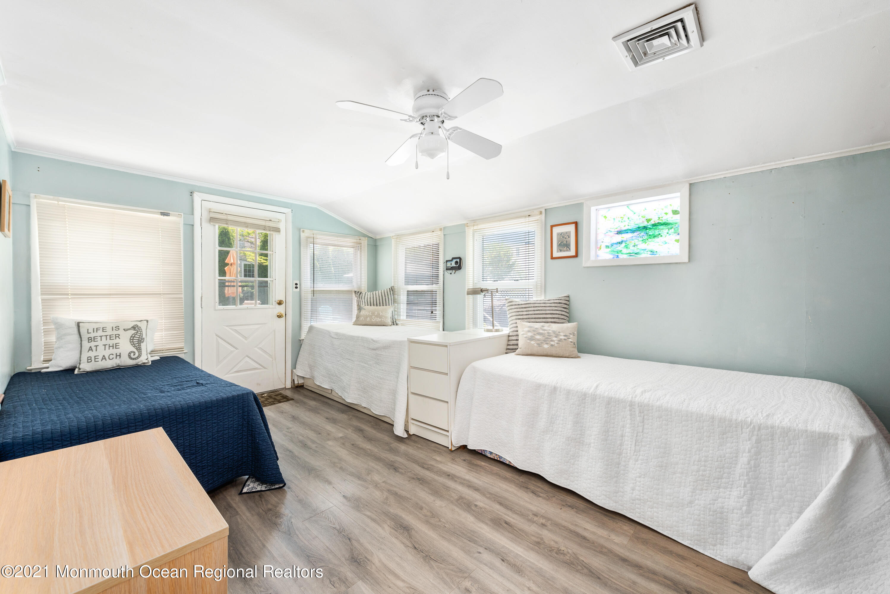 1709 Brighton Lane, Unit WINTER 2324 Spring Lake, NJ 07762 - Photo 15 of 27 a spacious bedroom with a bed and a chandelier