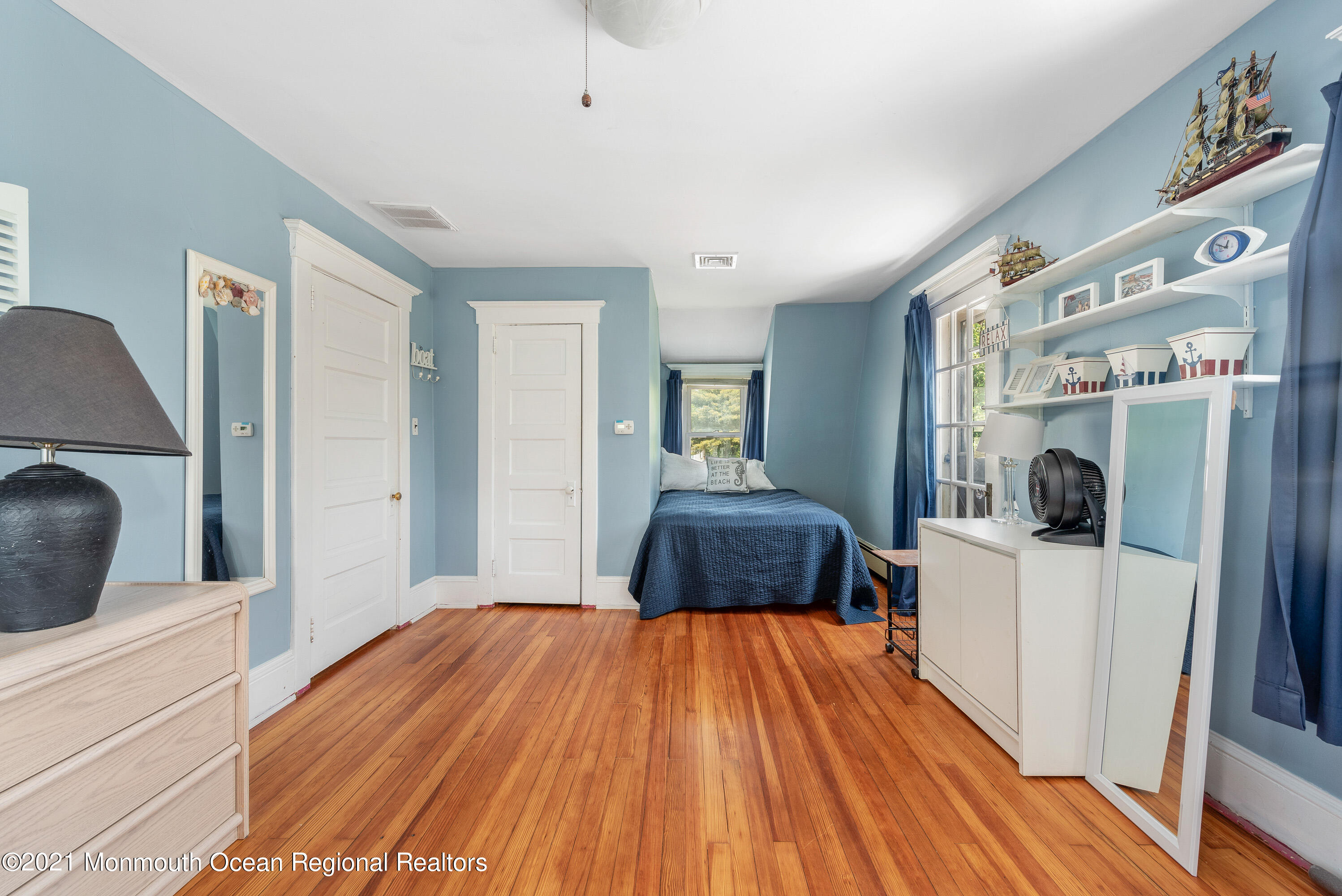 1709 Brighton Lane, Unit WINTER 2324 Spring Lake, NJ 07762 - Photo 21 of 27 a bedroom with a bed and a large window