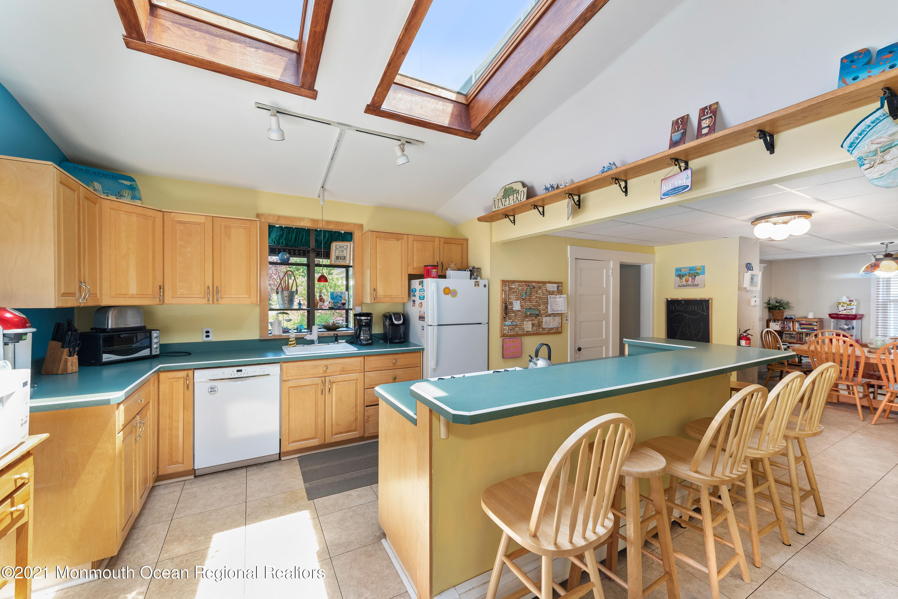 1709 Brighton Lane, Unit WINTER 2324 Spring Lake, NJ 07762 - Photo 10 of 27 a large kitchen with kitchen island a large counter space a sink appliances and cabinets