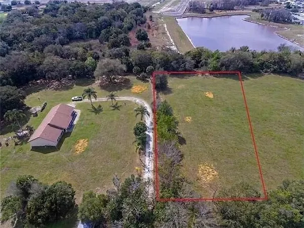 an aerial view of residential house with outdoor space and swimming pool