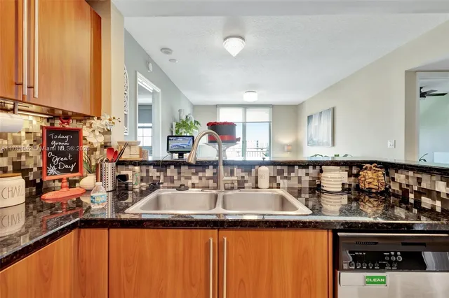 a kitchen with sink a counter top space and cabinets