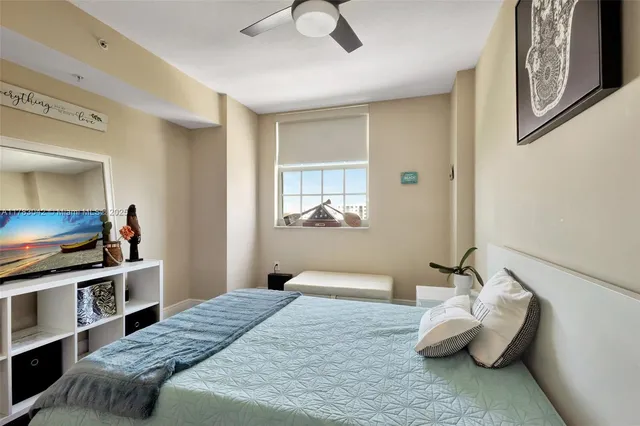 a bedroom with a bed and a television