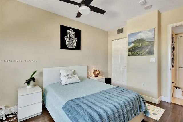 a bedroom with a bed and a painting on the wall