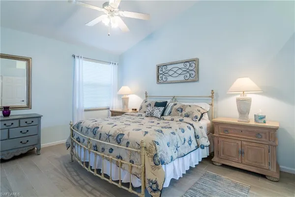 a bedroom with bed and paintings on the wall