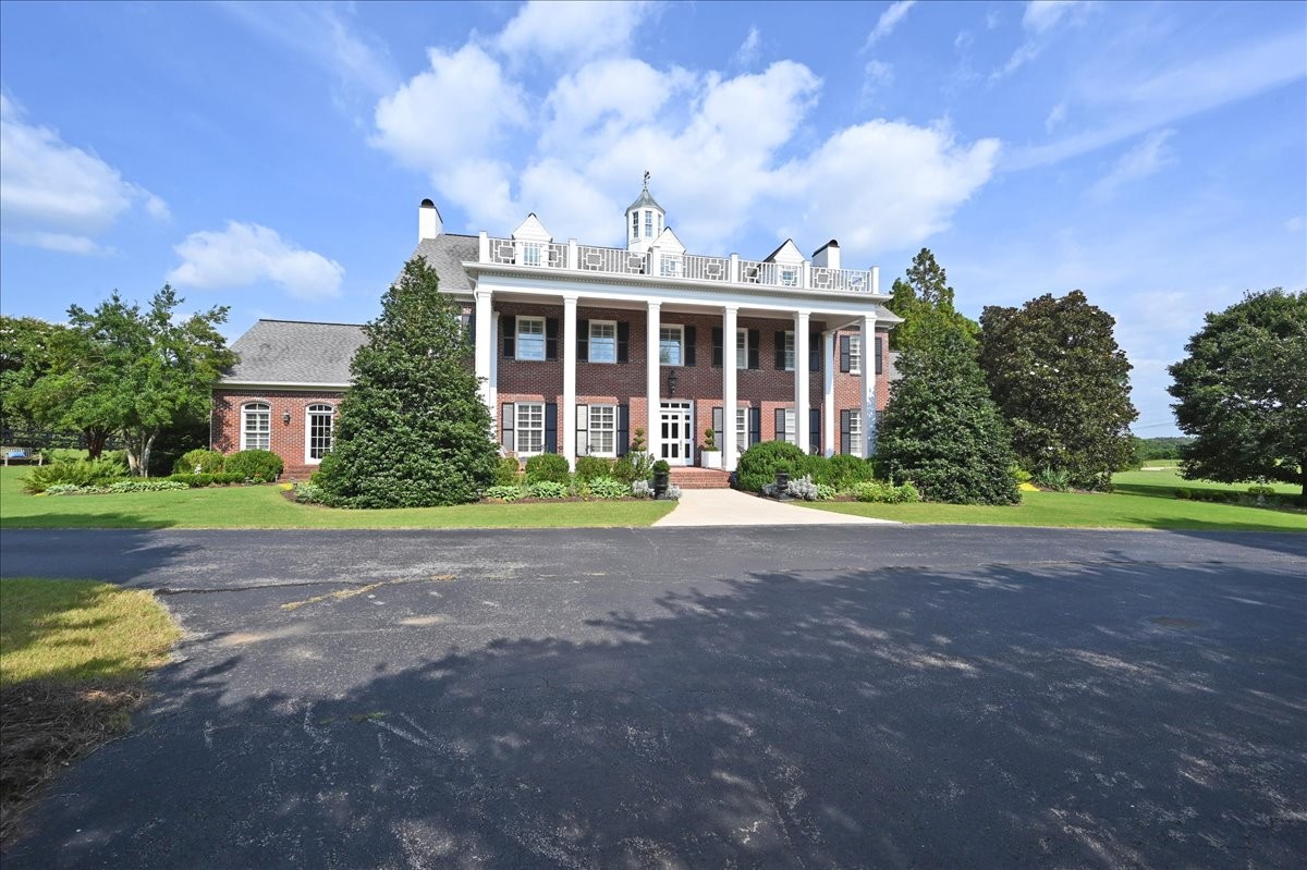 3062 Lower River Road Southeast Decatur, AL 35603 - Photo 6 of 70 a front view of a house with a yard and potted plants