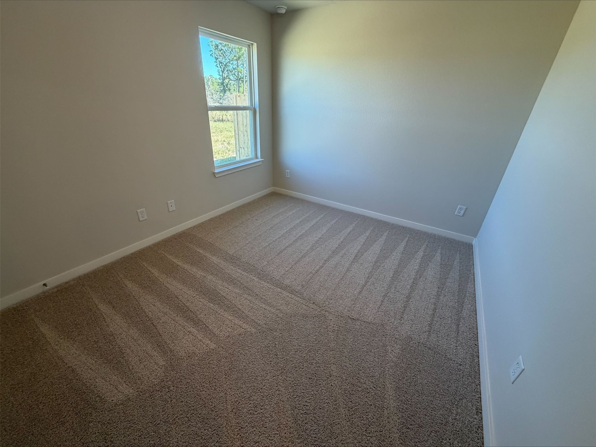 237 New Dawn Trail Huntsville, TX 77320 - Photo 14 of 23 a view of an empty room and window