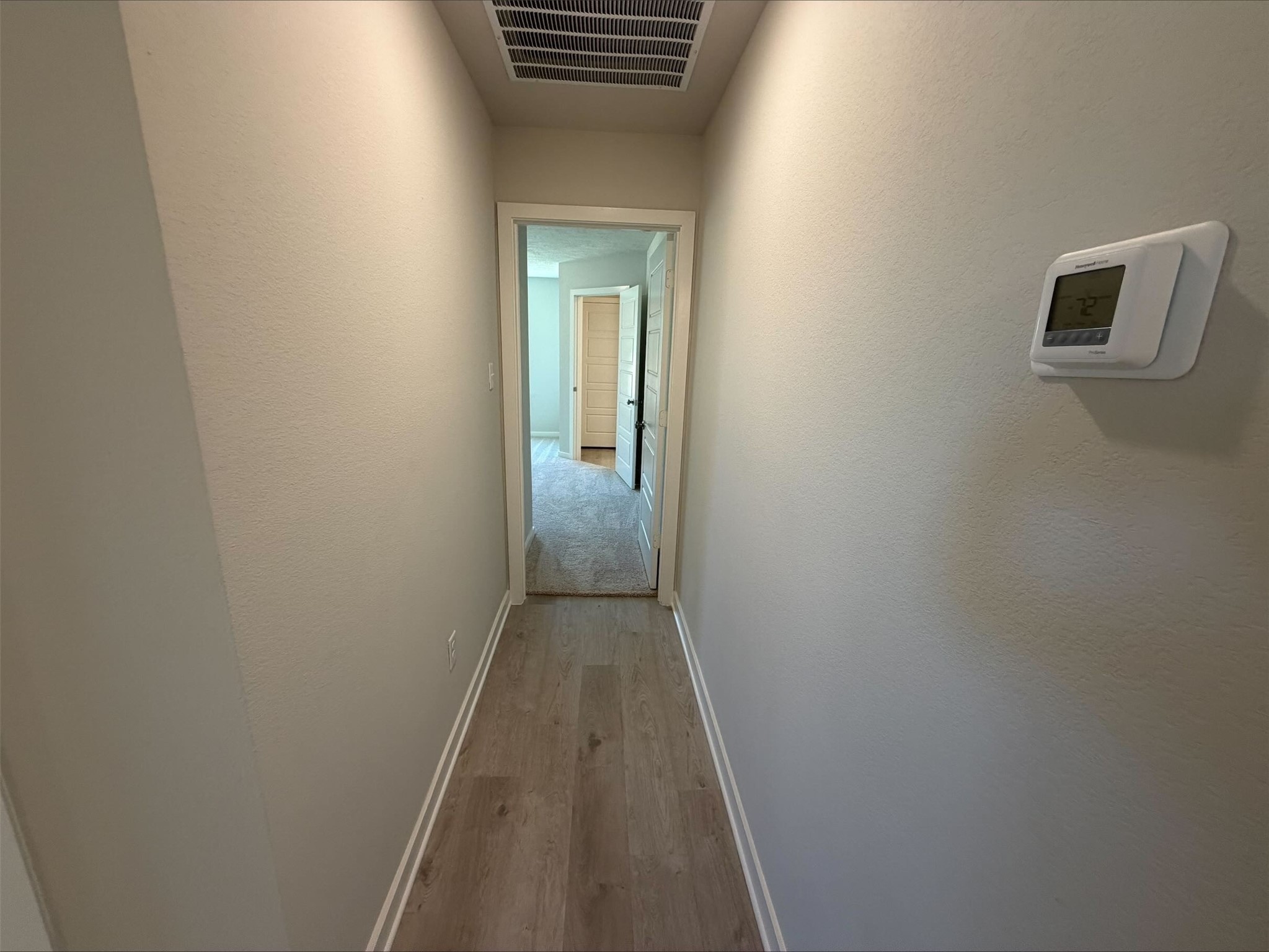 237 New Dawn Trail Huntsville, TX 77320 - Photo 16 of 23 a view of a hallway with wooden floor