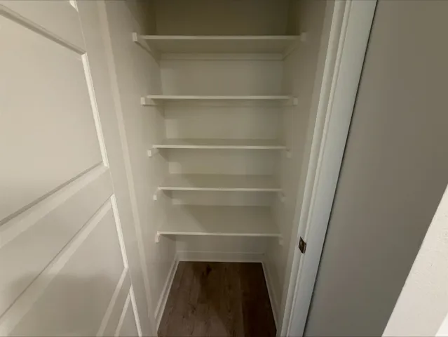 a view of walk in closet with empty racks