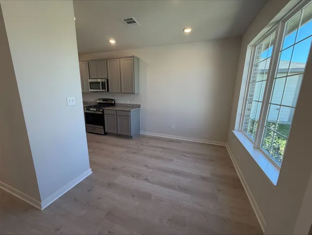 a kitchen with stainless steel appliances a refrigerator and a stove top oven