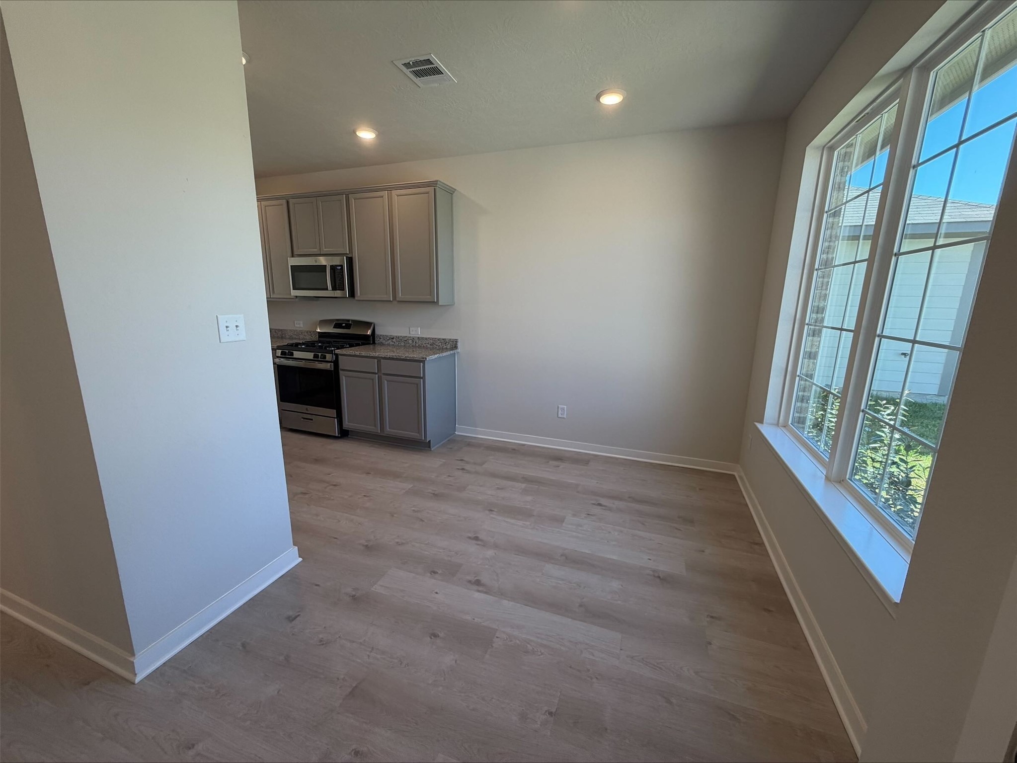 237 New Dawn Trail Huntsville, TX 77320 - Photo 3 of 23 a kitchen with stainless steel appliances a refrigerator and a stove top oven