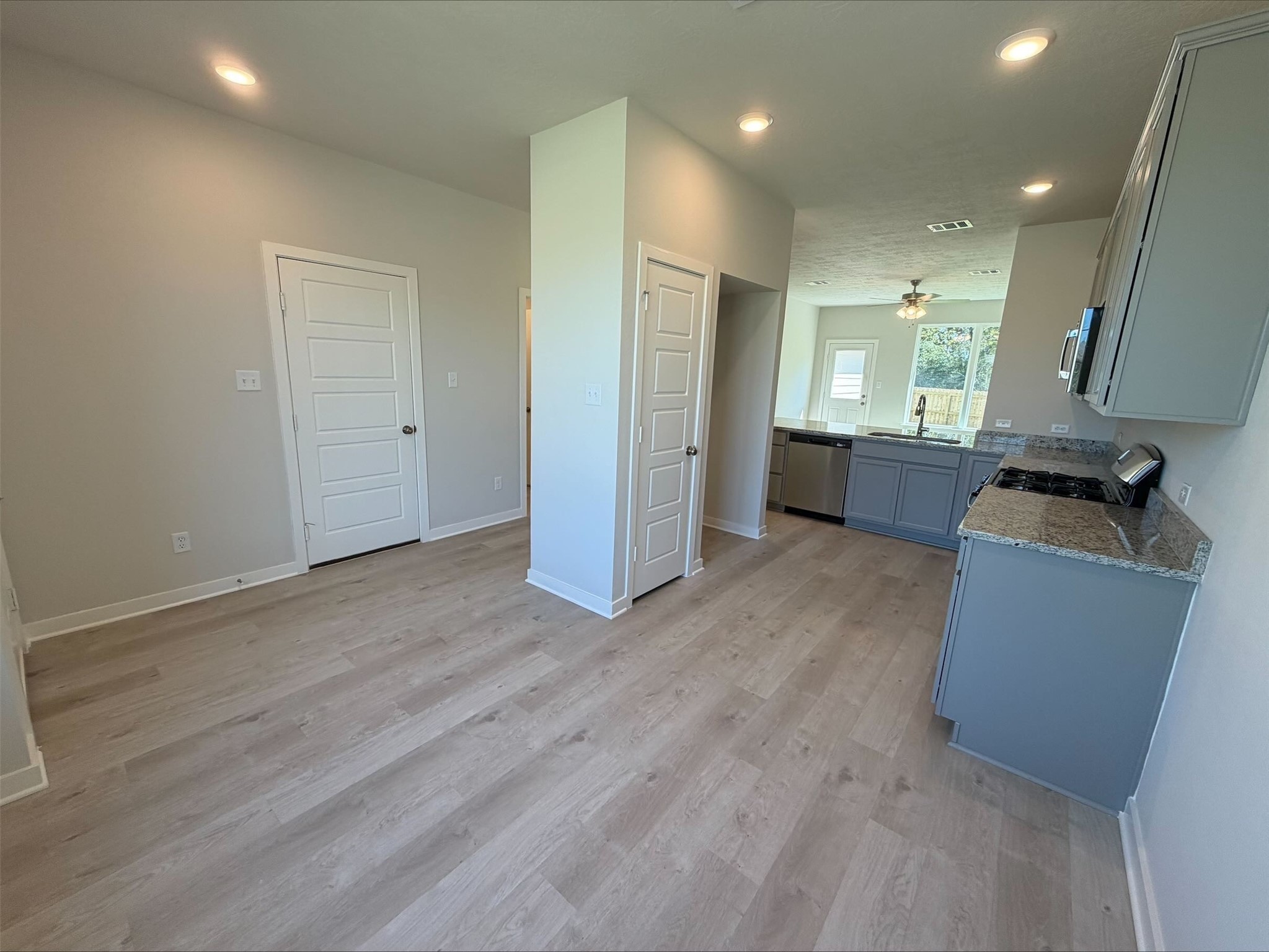 237 New Dawn Trail Huntsville, TX 77320 - Photo 4 of 23 an empty room with wooden floor and windows